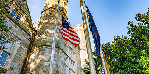 American flag waving infront of phillis memorial building