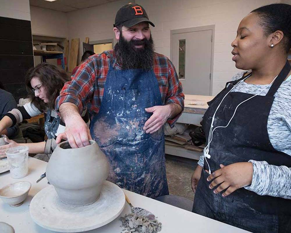Faculty member working with student at table