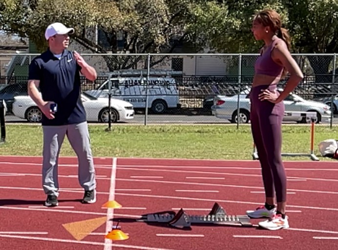 Photo of Ken Clark and Gabby Thomas on track field