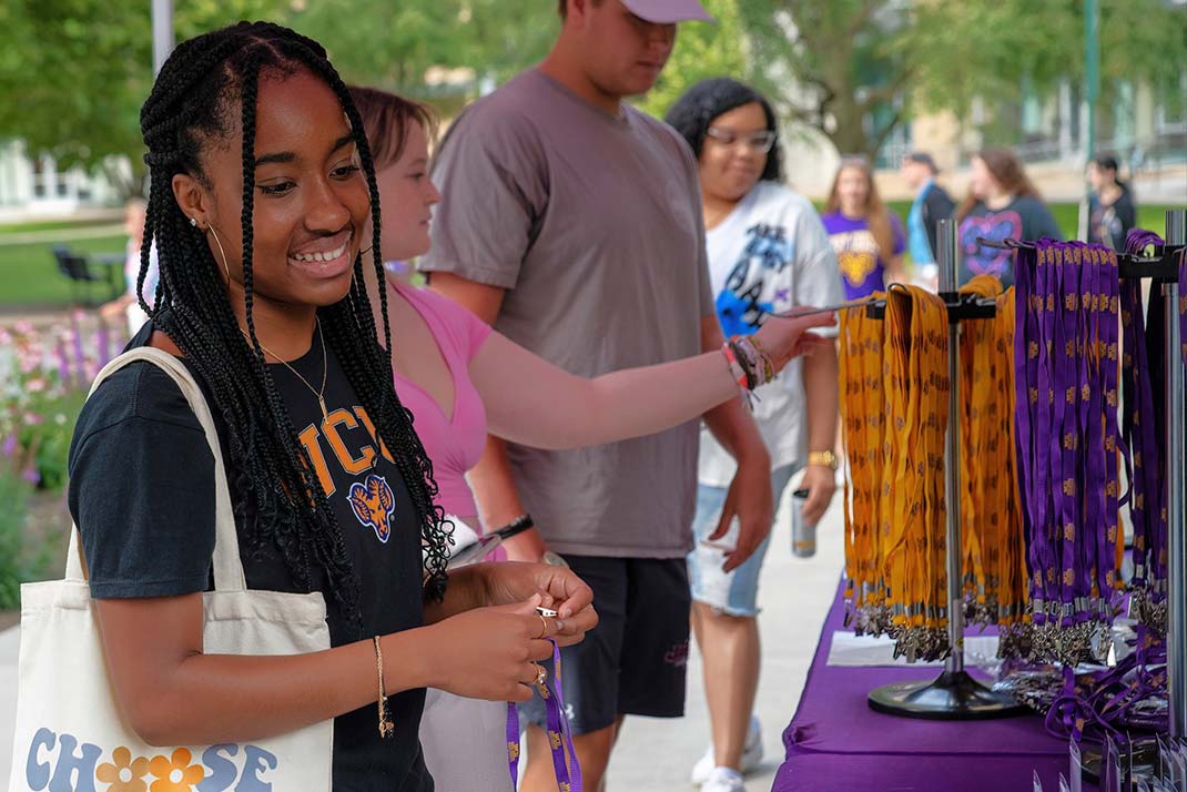 Student posing for a picture buying items