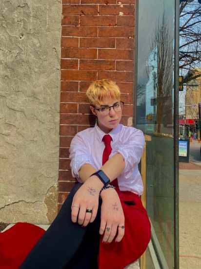 august sitting on a concrete ledge 