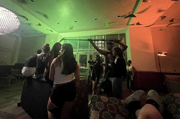 ICamp tv production with students holding boom mics above