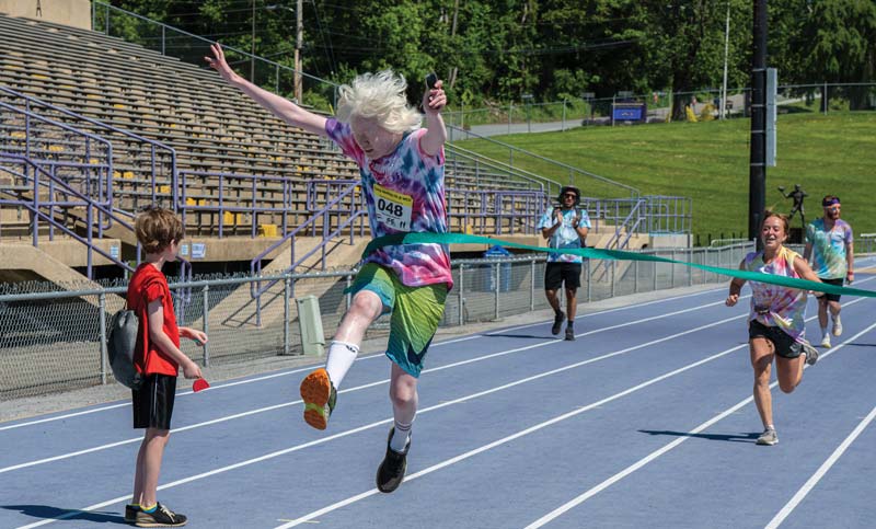 Image is of a runner winning their competition