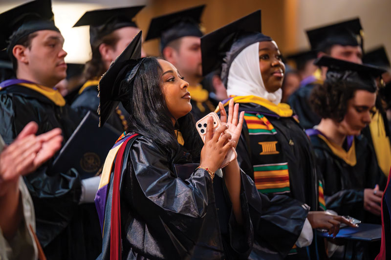 Crowd of graduates clapping