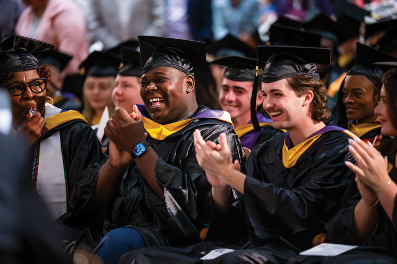 Another crowd photo of graduates clapping
