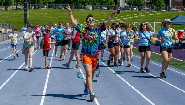 Dr Elizabeth Foster (center) inspires Camp Abilities athletes and coaches at the triathlon