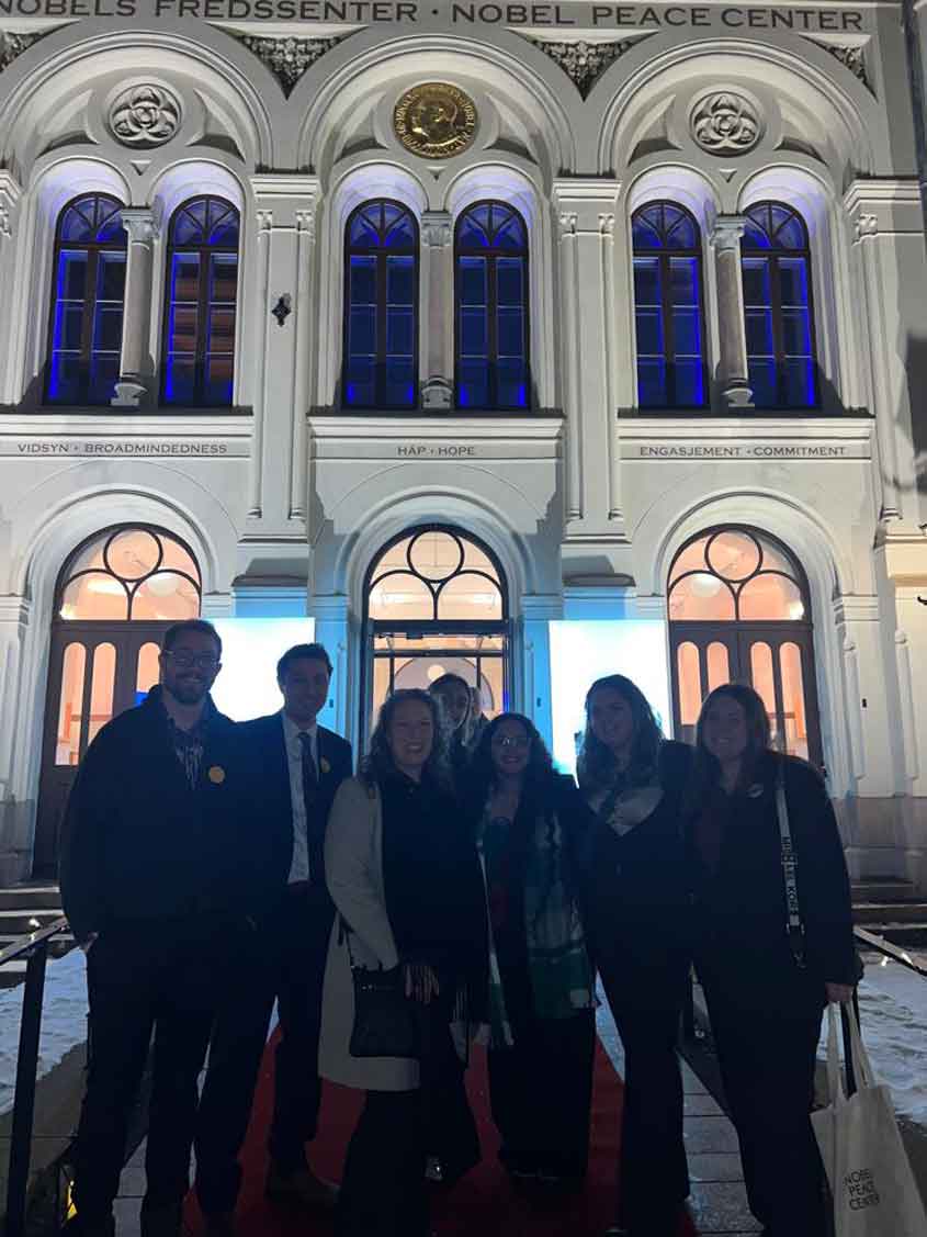 Group posing in front of building