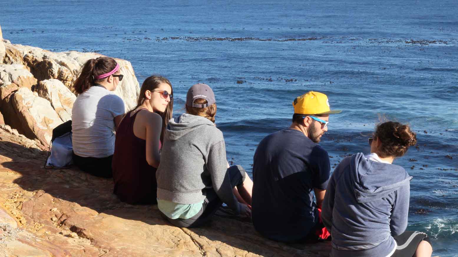 Group sitting by the sea