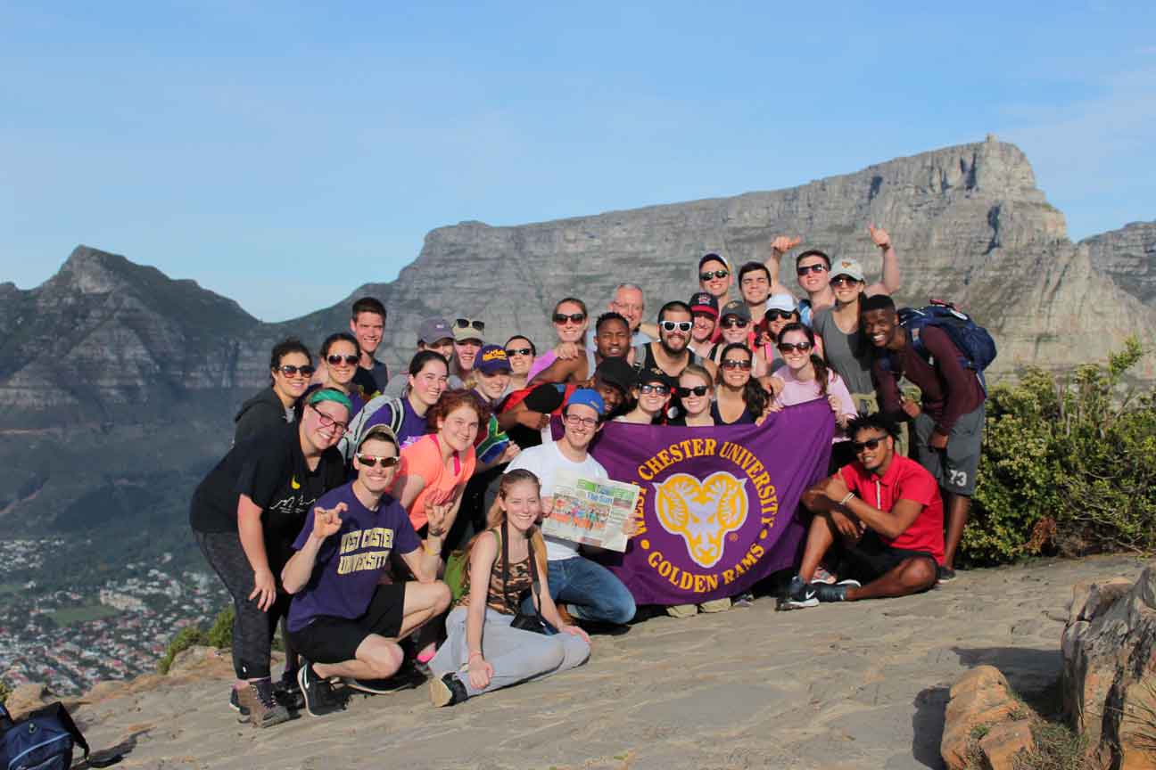 Group posing with WCU flag