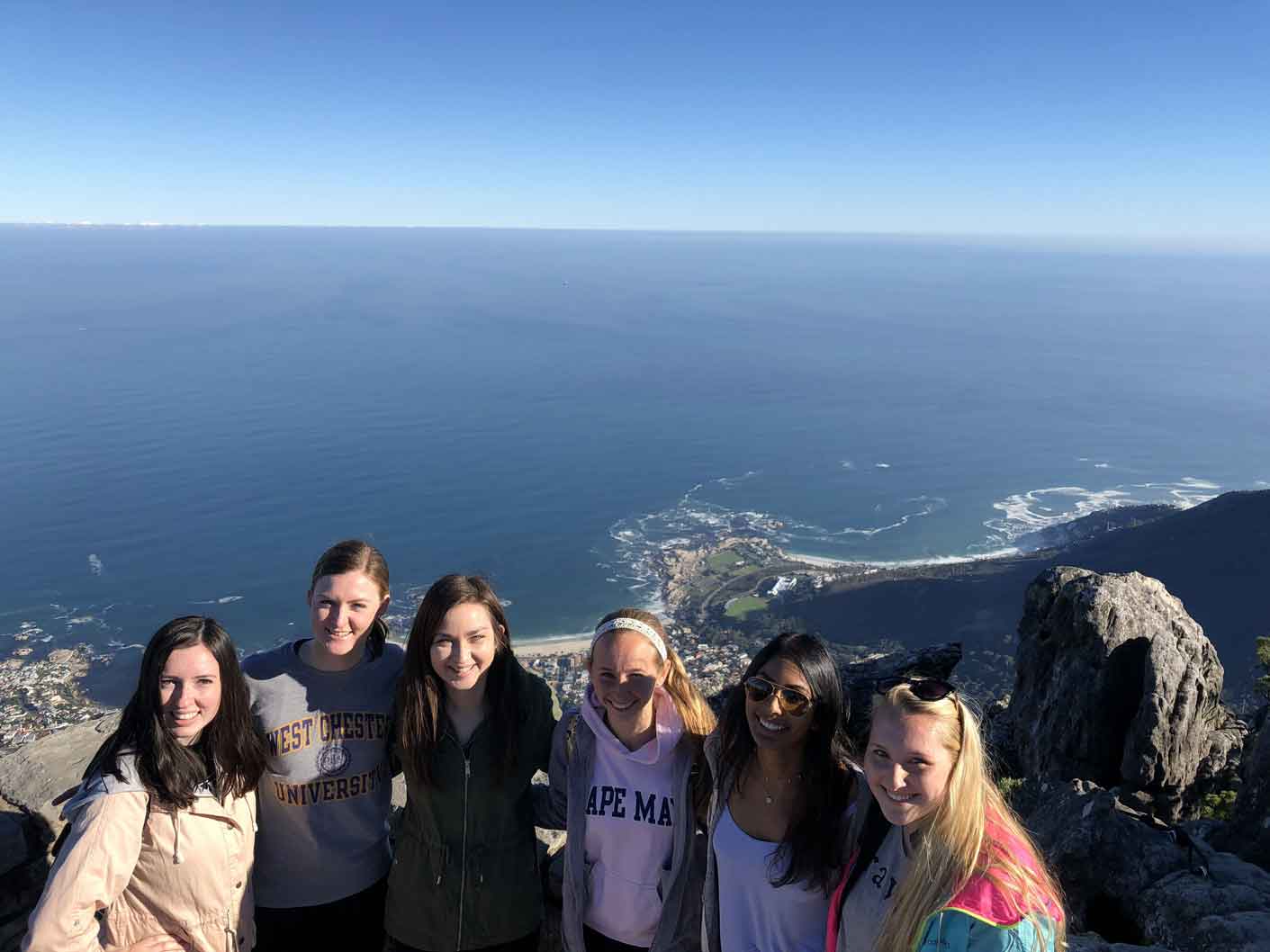 Group posing behind an ocean