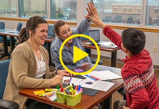 Student and teacher high-fiving