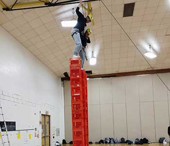 Students climbing crates