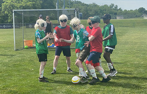 Adaptive PE students plaing soccer