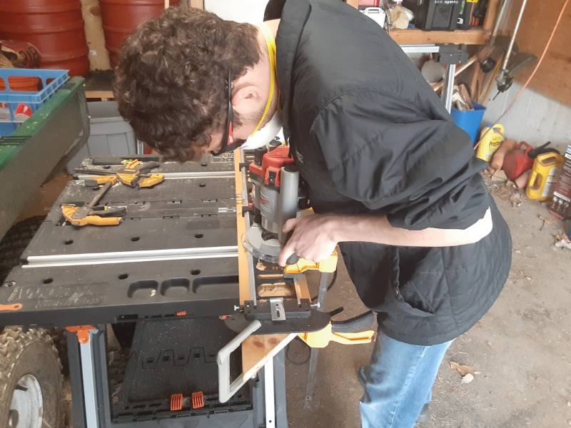 GNA intern Alex Desjardins routing a sign. 