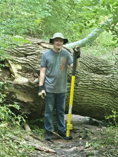 GNA Student Intern Jack Ridenour next to a large, fallen Tulip Tree