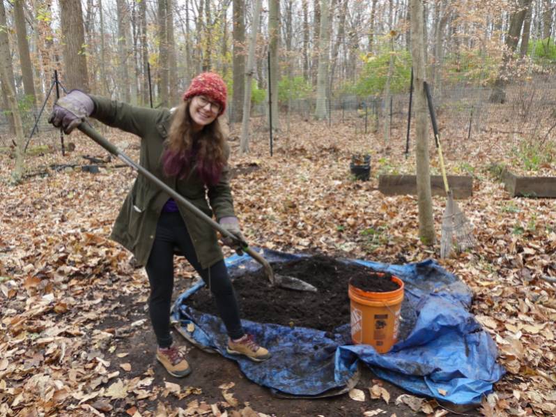 Kathryn inoculating biochar by mixing it with compost and fungal spawn