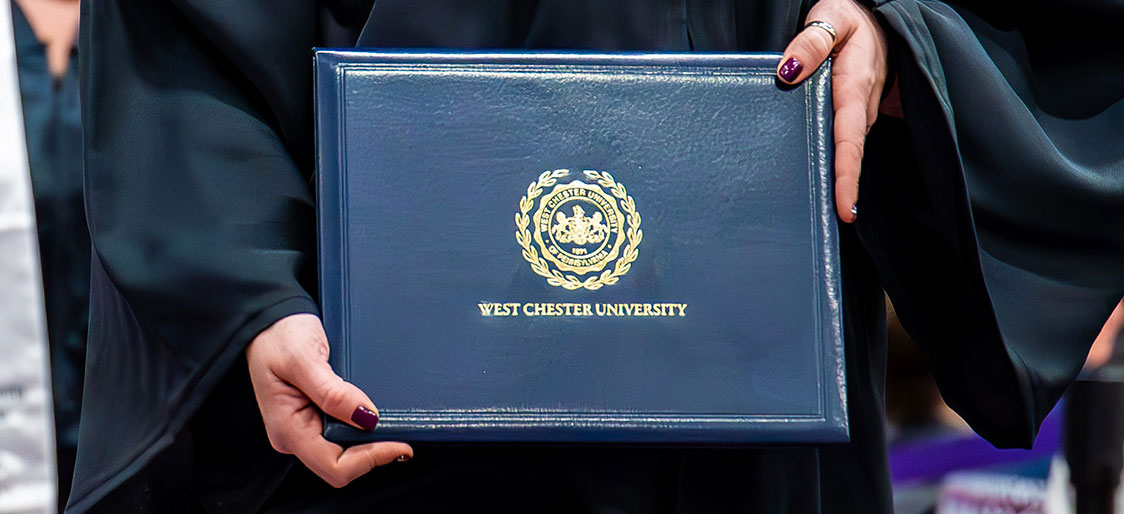 WCU graduate holding diploma