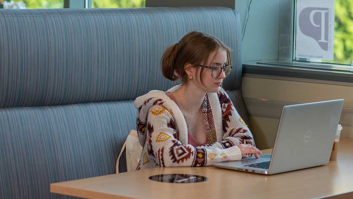 student on laptop in sykes